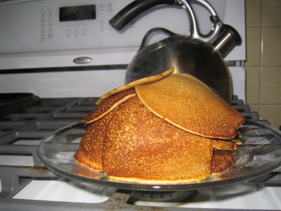 plate of buckwheat pancakes, with teakettle for scale